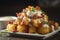 Beautifully decorated tater tots with cheese and sour cream on a white ceramic plate. 